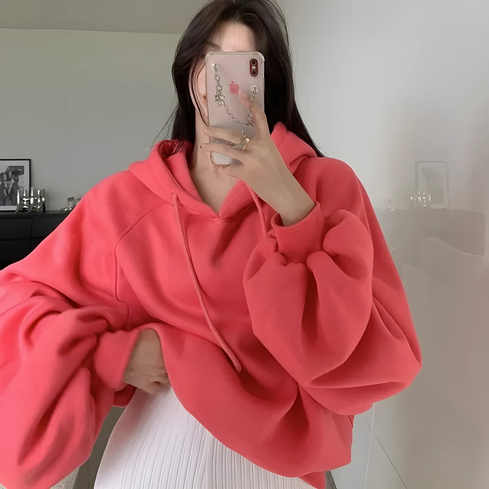 Women's watermelon red sleeveless hooded sweater made from mulberry silk fabric on a hanger