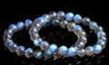 Natural blue moonlight cream body crystal bracelet on wrist, showing single strand of polished beads.
