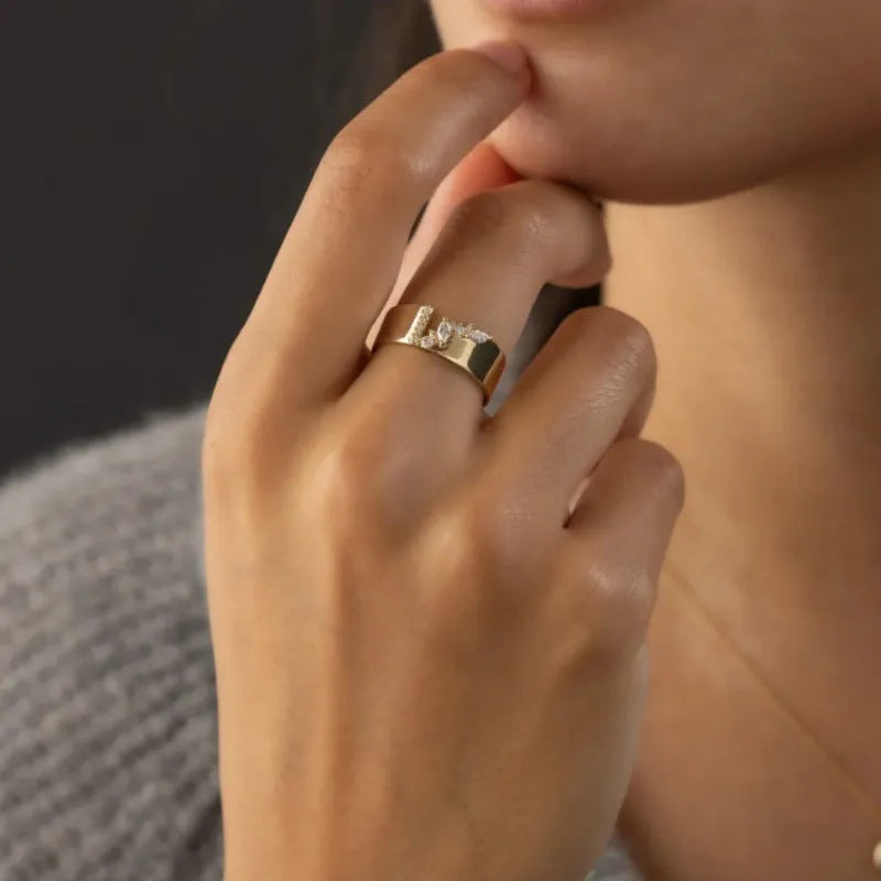 Gold electroplated women's ring with shining zircon stones on a copper band.