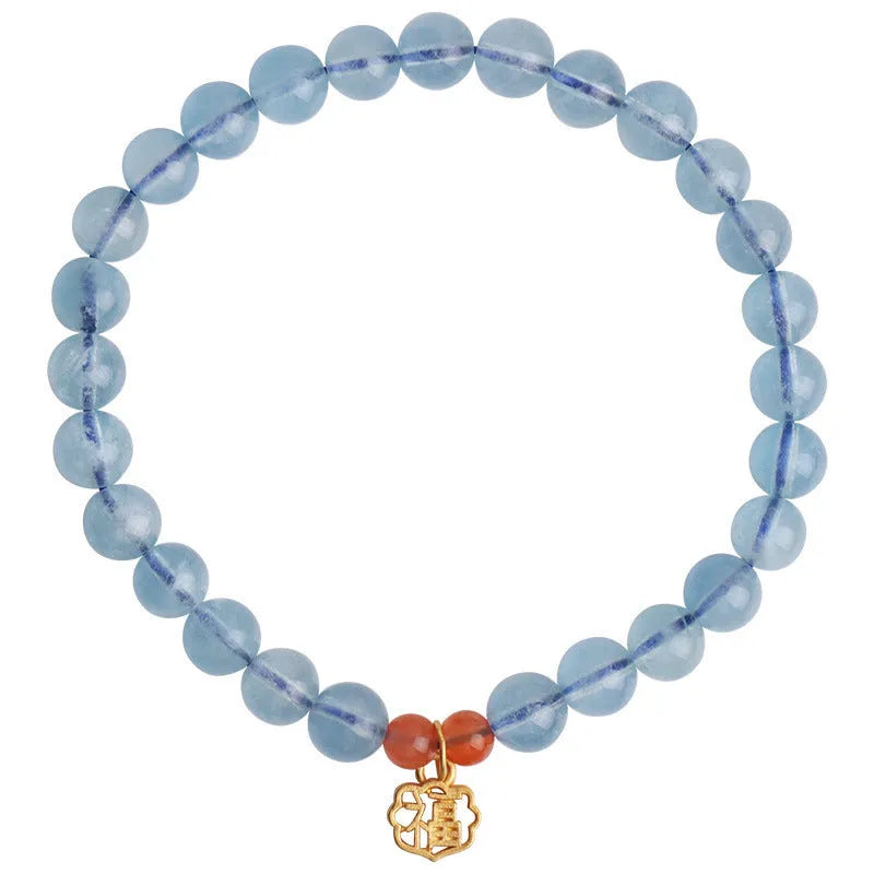 Ice translucent aquamarine crystal bracelet with 8mm round beads and sequins on a wrist.