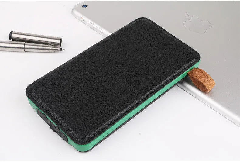 Black outdoor solar phone charger with leather exterior, solar panel, and LED light.