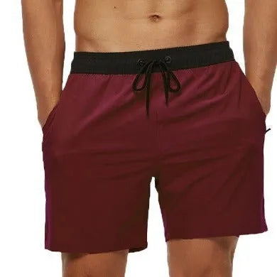 Men's blue stitching waist running shorts with a zippered pocket and drawstring.