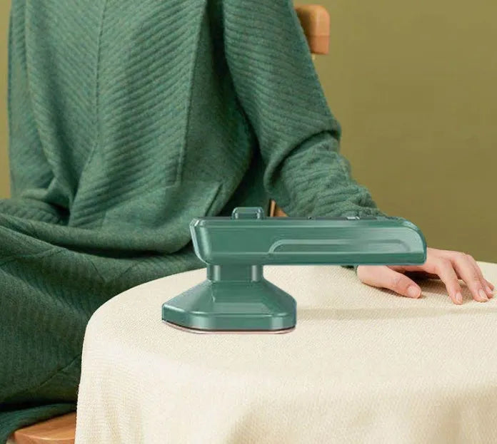 Dark green portable hanging steam iron with ceramic panel, compact design for travel garment care