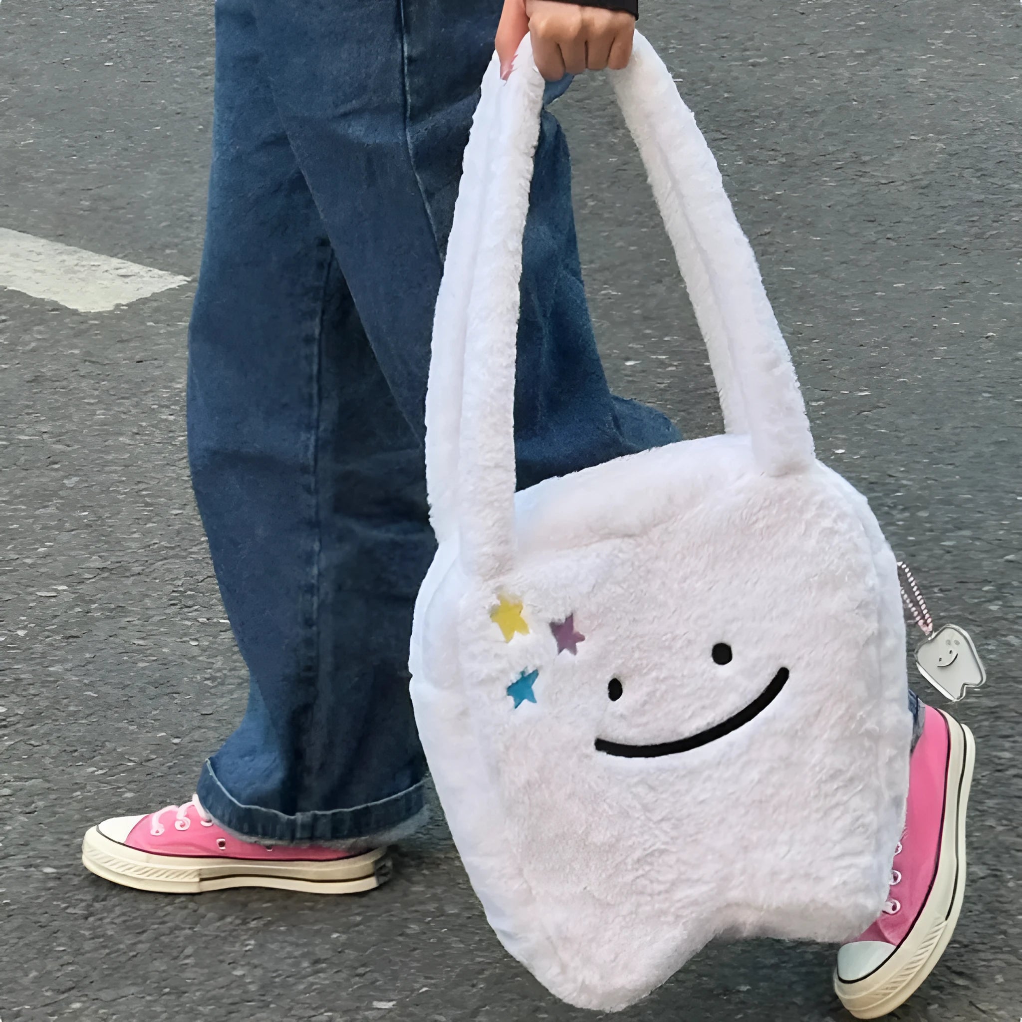 White plush tote bag with cute teeth pattern, showing crossbody strap and zipper closure.