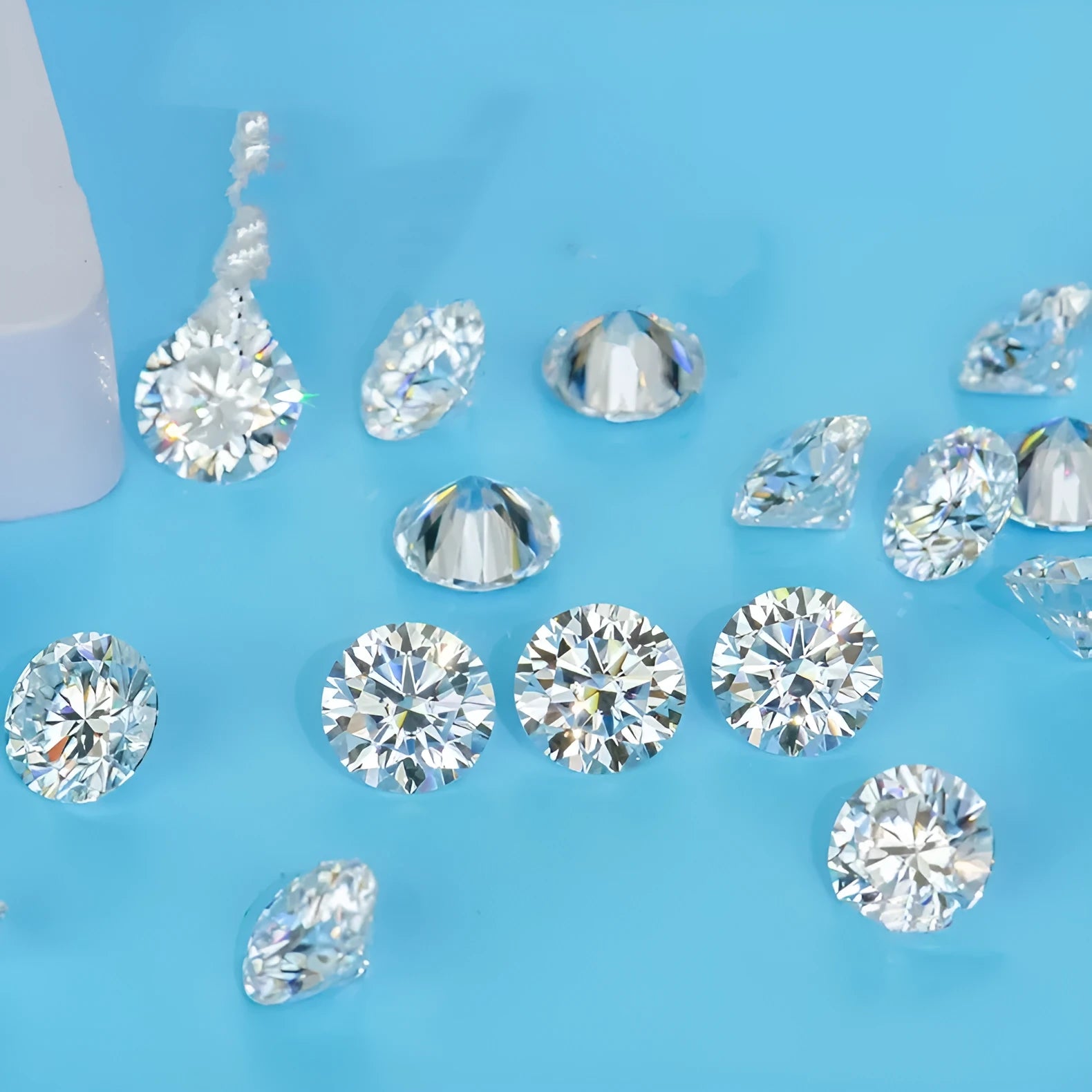 Round moissanite loose gemstone with eight hearts and eight arrows cut on a dark surface