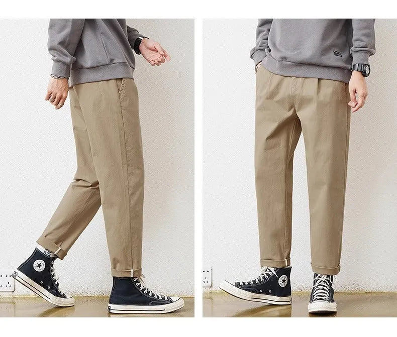 Men's loose wide-leg casual pants in dark khaki with zipper fly and mid-rise waist on a plain background