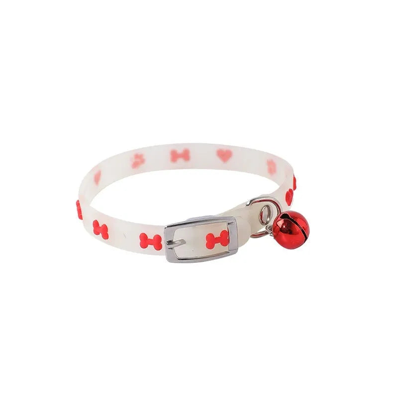 Glow in the dark adjustable silicone cat collar with metal bell in paw print pattern.
