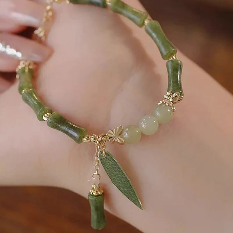 Chinese style glass bead bracelet with bamboo leaf design and manual craftsmanship details.