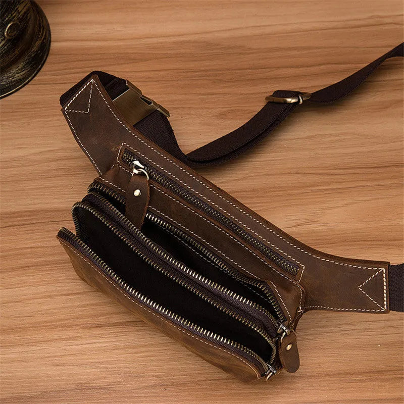 Brown cowhide leather men's sports waist bag with zip, shown with phone in internal pocket.