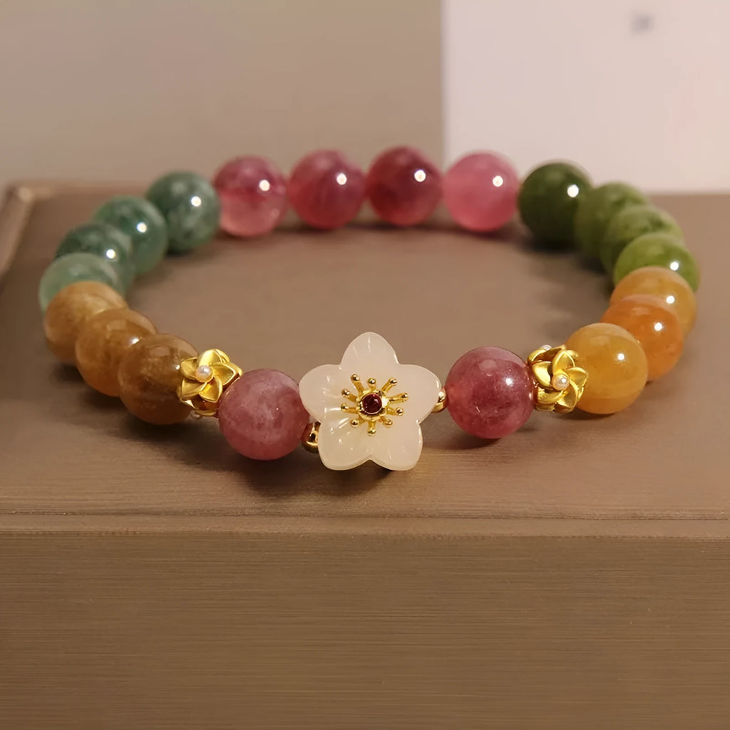 Natural colour tourmaline bracelet with electroplated finish showing geometric shape and delicate flower design