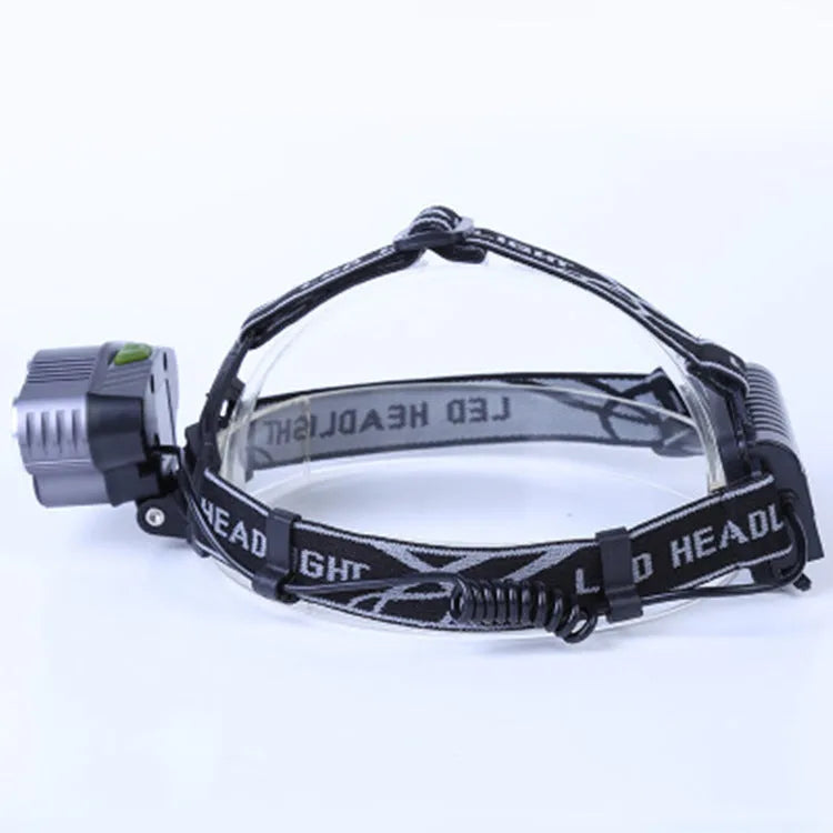 Fixed focus LED head torch with head strap, shown with its included charger.