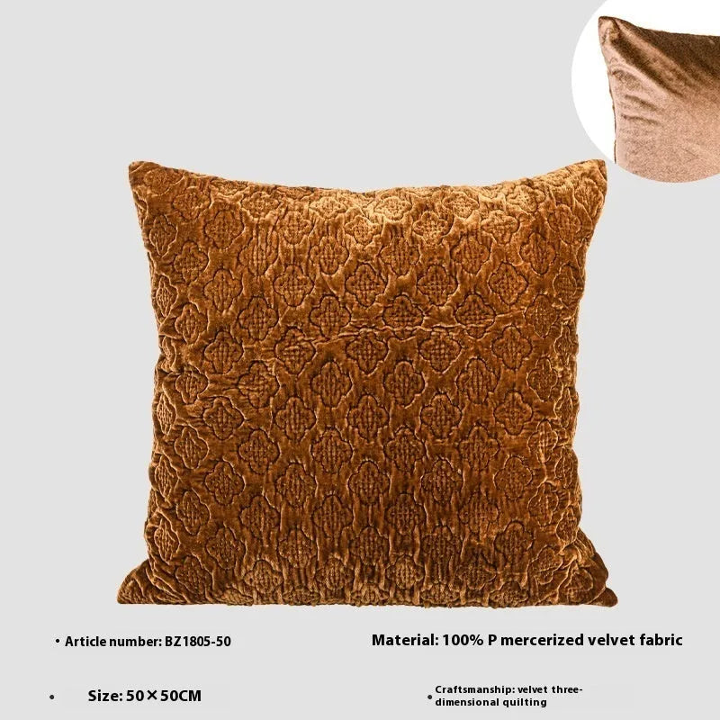 Brown gold antique-style quilted square cushion pillow and matching lumbar pillow on a sofa.