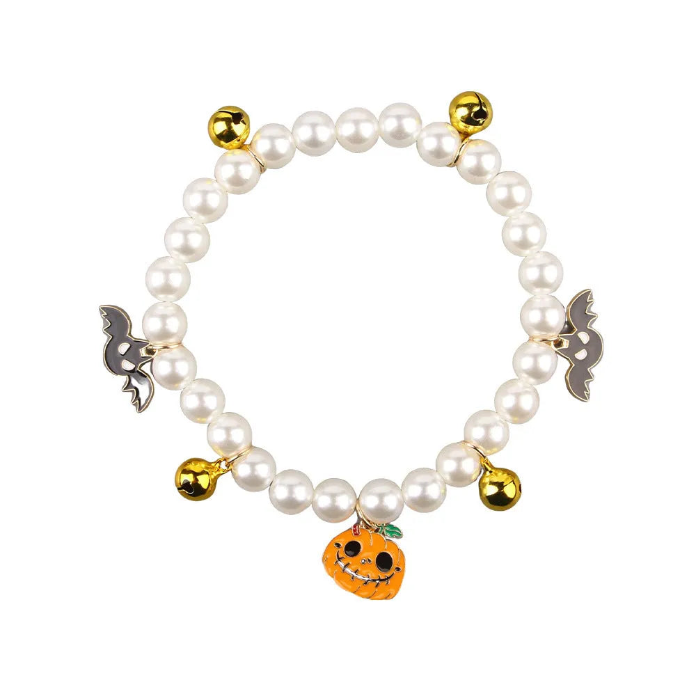 Halloween decorative pet collar with simulated pearl necklace and pumpkin designs in purple, black, and orange.