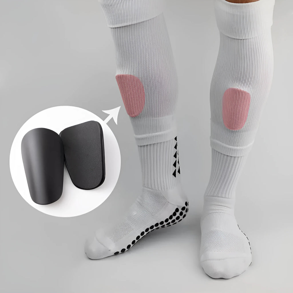 Pair of PU mini shin guards in Dream Blue colour, shown on a leg for scale.