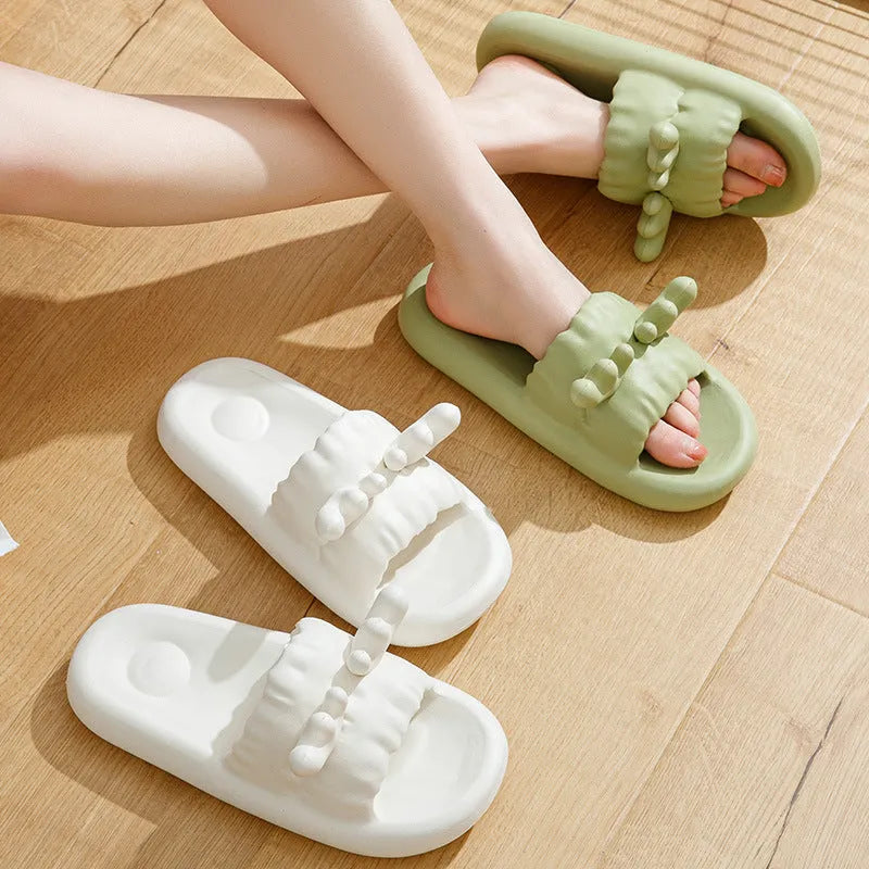 White deer horn pattern EVA flip-flop slippers with hollow-out design on a bathroom floor