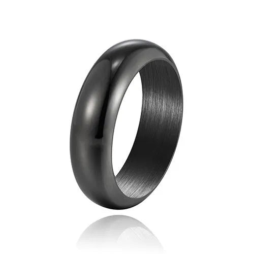 Glossy electroplated titanium steel ring in gold, black, and steel colours on a jewellery background.