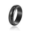 Glossy electroplated titanium steel ring in gold, black, and steel colours on a jewellery background.