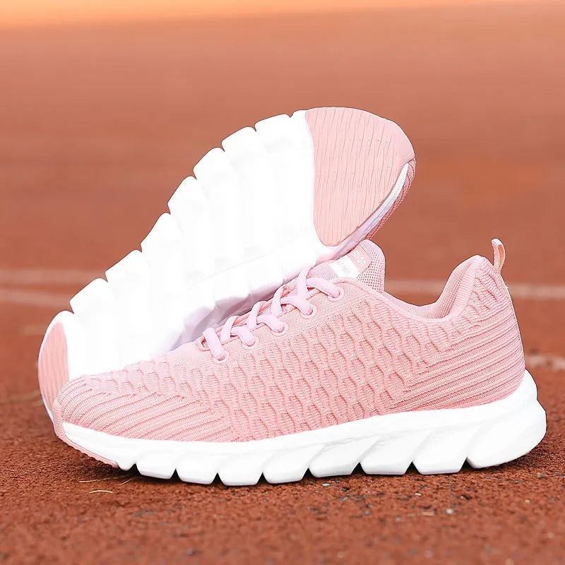 Women's running shoes with fly weaving upper in black, pink, or white colours, showing durable outsole.