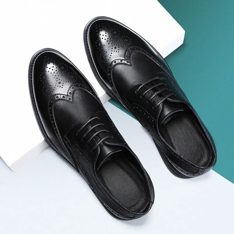 Men's black and brown brogue leather shoes for business style on a plain background.