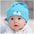 Baby soft cotton sleeping cap with cartoon bear design in blue, gold, and pink colours