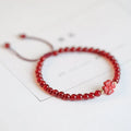 Hand-woven red agate bracelet with diamond beads in ethnic woven pattern