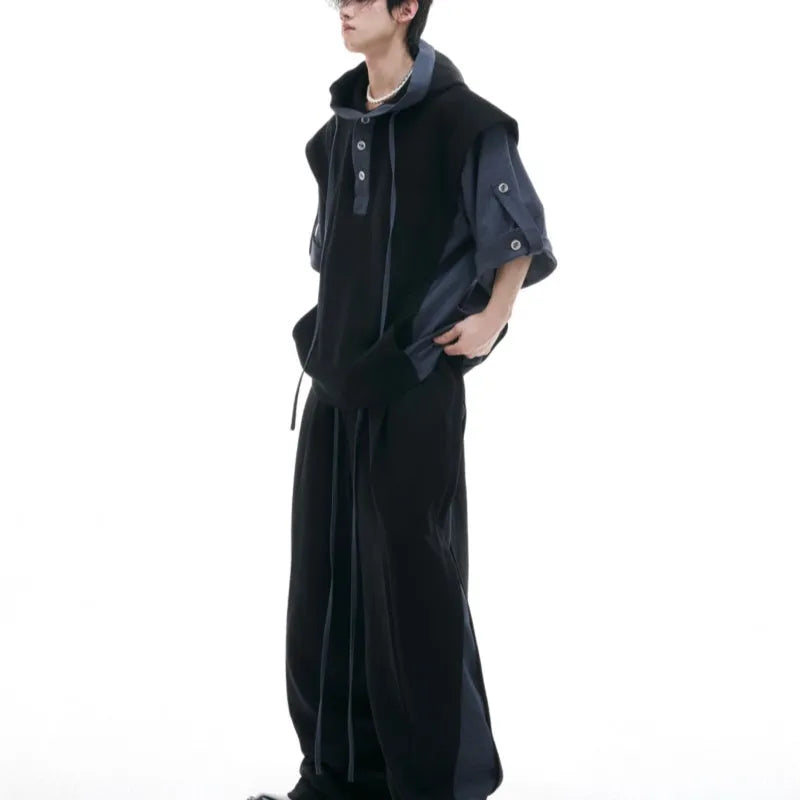 Men's black hooded short sleeve polyester sports suit with textured stitching and matching trousers on a grey background.