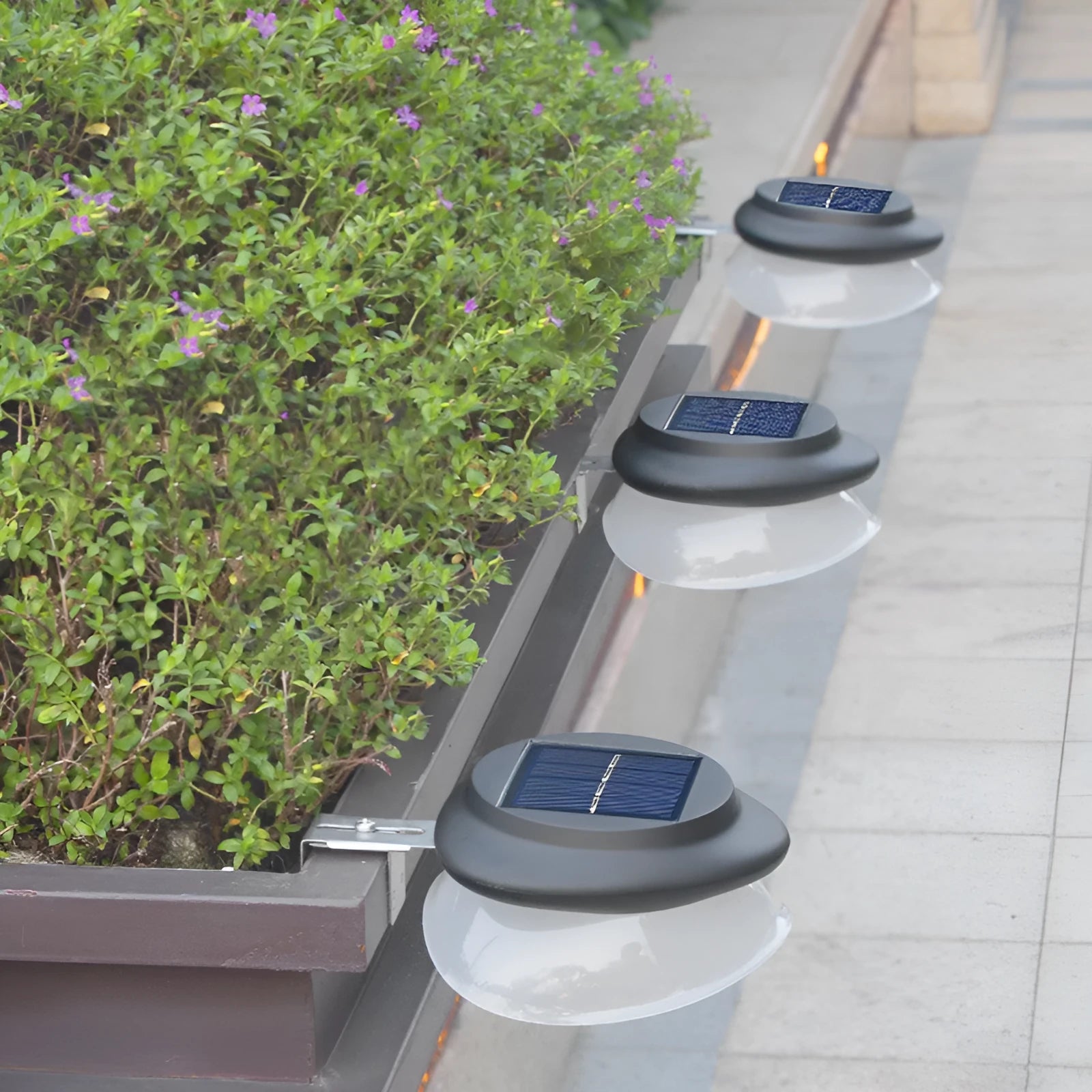 Solar-powered outdoor fence wall lamp with Southeast Asian design in garden setting