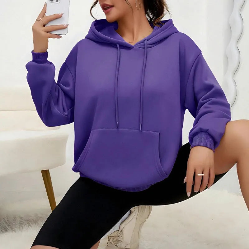 Women's loose grey drawstring pocket sweatshirt with long sleeves and a front pouch.