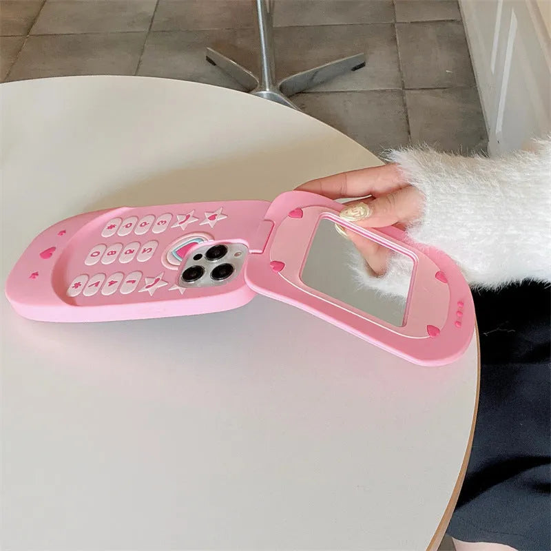 Light pink silicone flip phone case with built-in mirror for iPhone, showing cute cartoon design