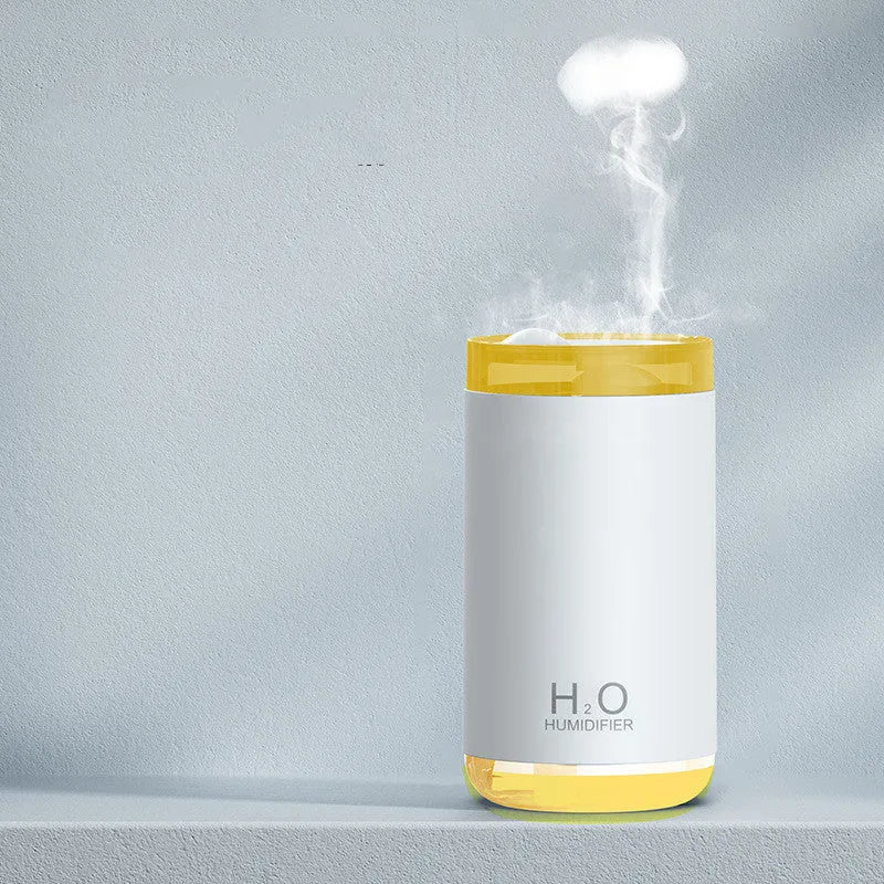 Mini USB jellyfish humidifier with warm night light in white, showing smoke-ring mist output