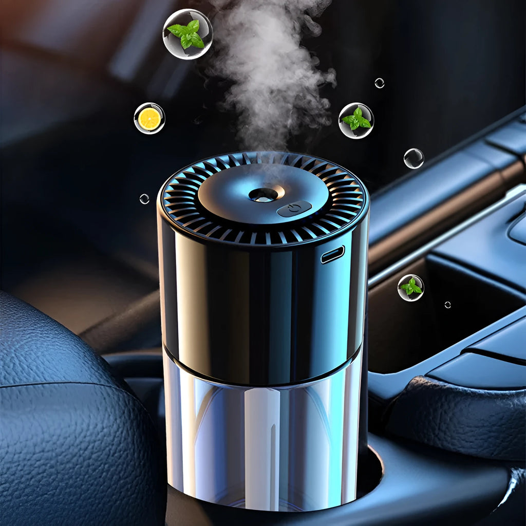 Compact USB plug-in spray perfume humidifier with glass seat on a desk.