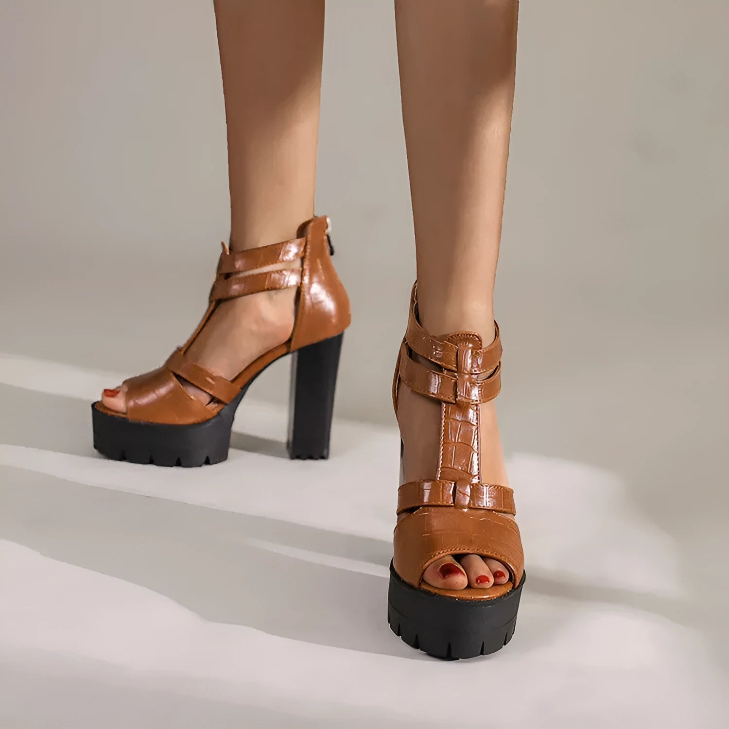 Women's black platform high heel sandals with a back zip and round toe on a rubber sole.