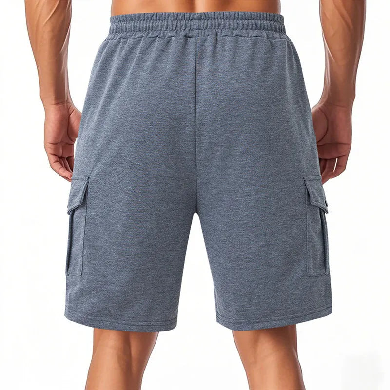 Man's heavy terry fabric cargo shorts in light grey, showing loose fit and multiple pockets.