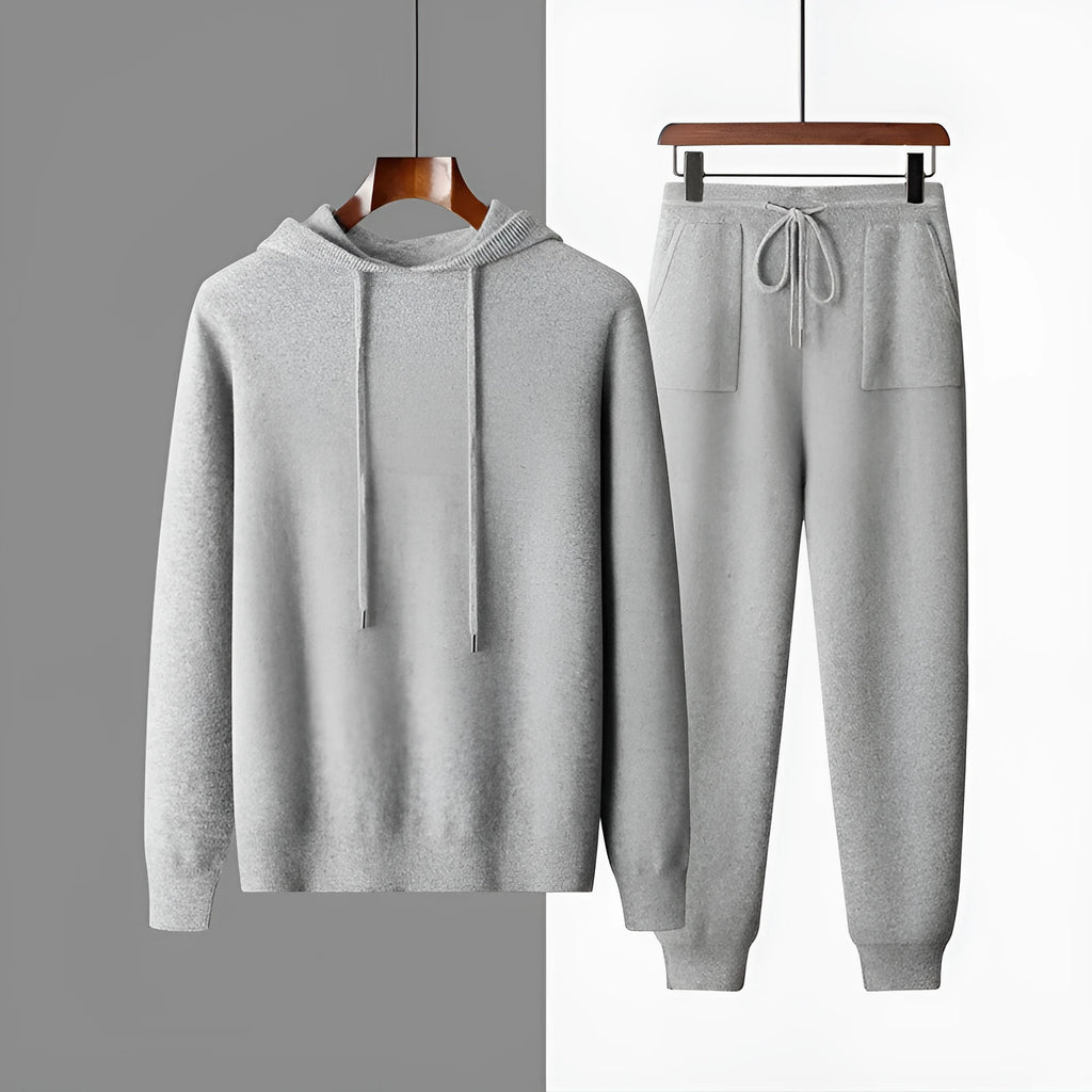 Men's dark grey cashmere hooded sweatshirt and matching long pants laid flat as a complete set.