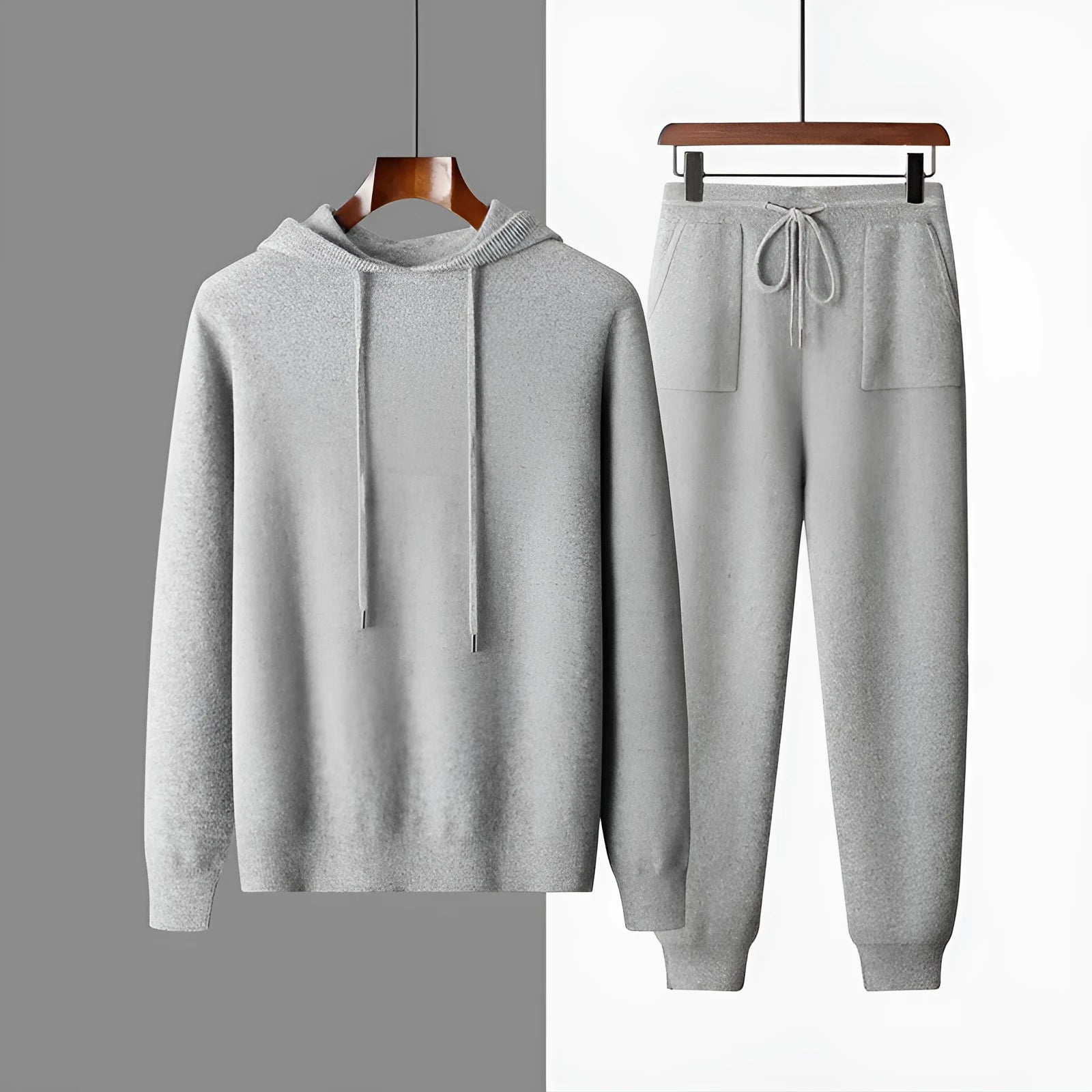 Men's dark grey cashmere hooded sweatshirt and matching long pants laid flat as a complete set.