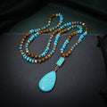 Turquoise blue water drop shaped pendant necklace with ball bead chain and geometric design elements