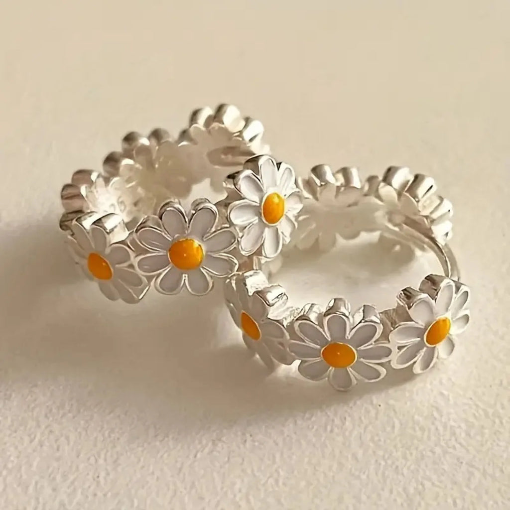 White daisy flower ring earrings with electroplated copper and platinum-accented gems.