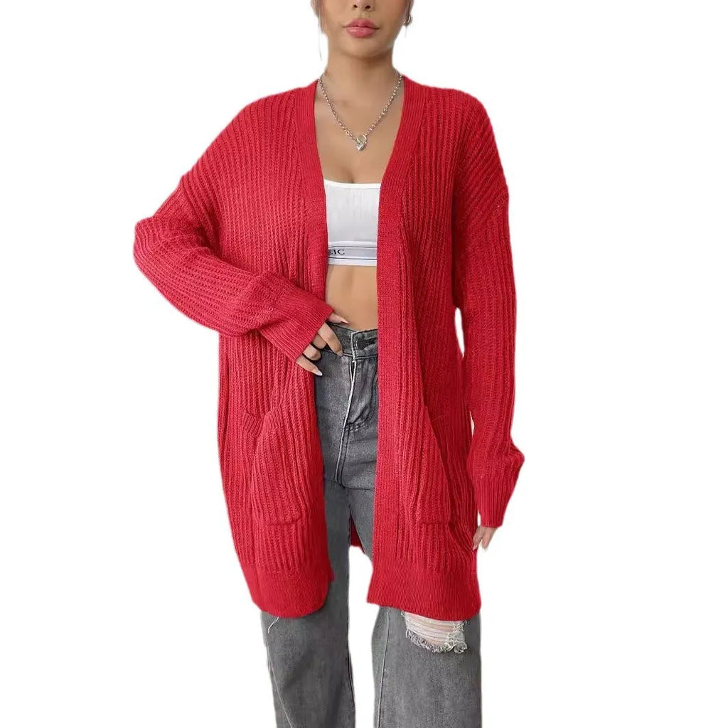 Women's dark green loose-fit cardigan with two front pockets and long sleeves.