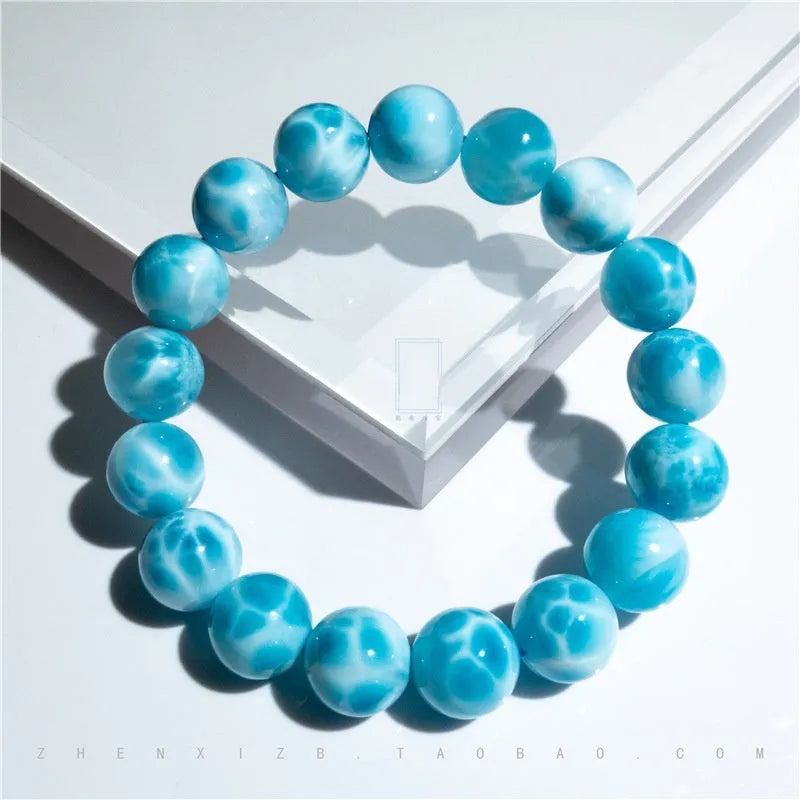 Unisex blue pearl and natural crystal sea-pattern stone bodhi bracelet on a wrist, showing Maillard style design.