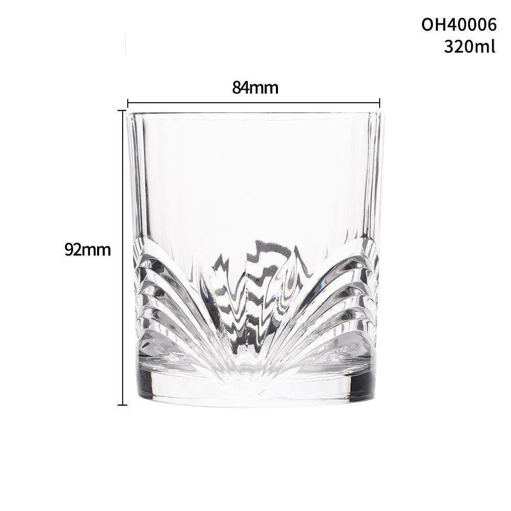 Clear thick-bottomed whiskey shot glass on a table showing 40ml capacity and solid base.