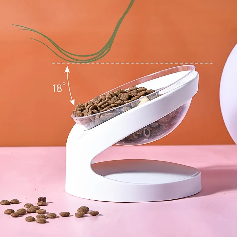White elevated tilted plastic cat food bowl on a flat surface