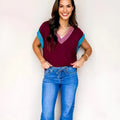 Burgundy V-neck loose sweater with contrast trim and cuffed short sleeves