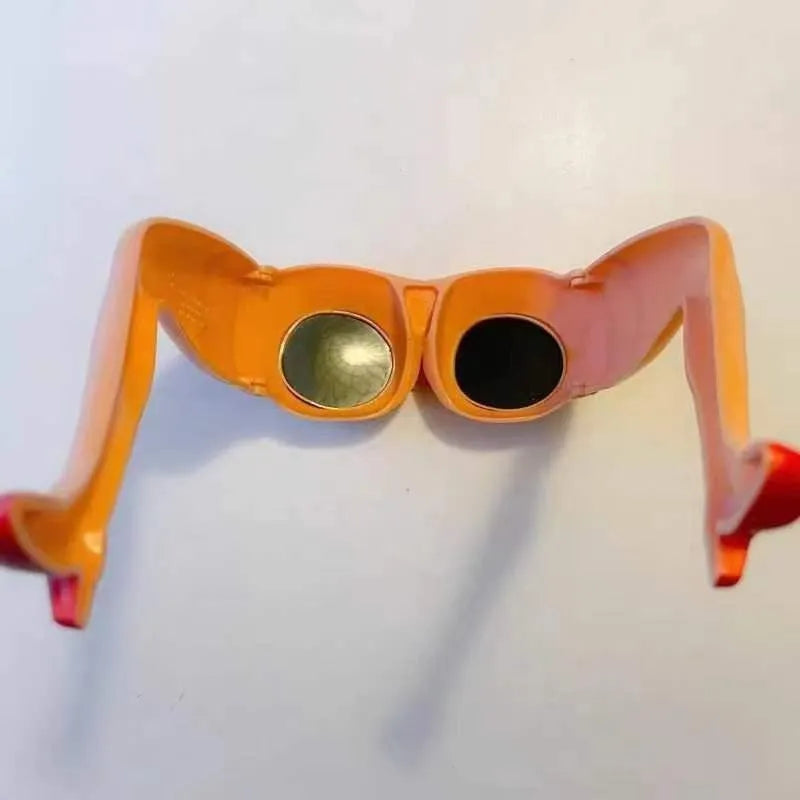 Orange novelty sunglasses with a leg and hip design on a white background.