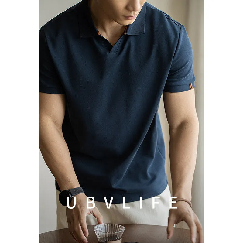 Men's blue short-sleeved cotton blend polo shirt on a hanger, showing regular fit and casual style.
