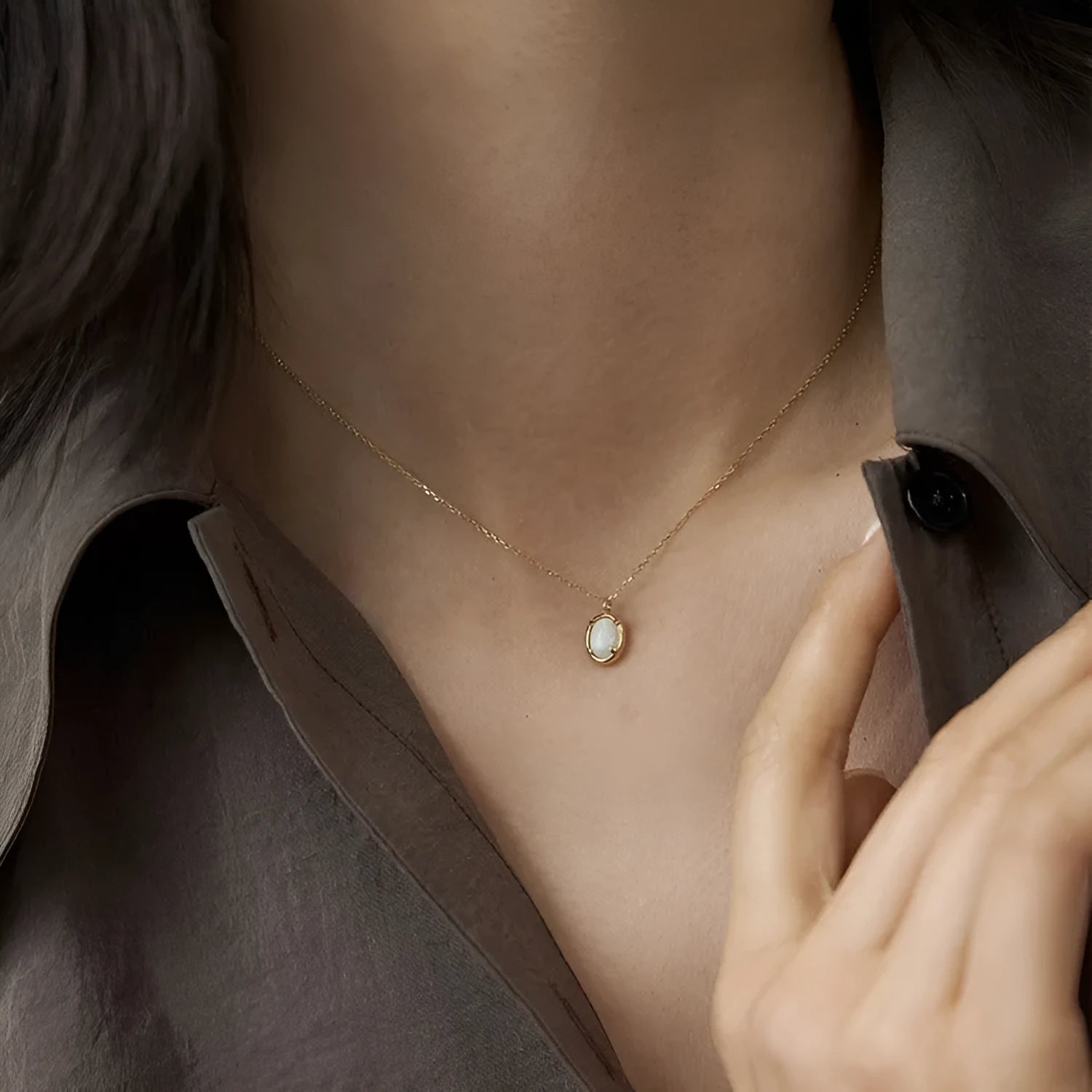 Oval geometric pendant necklace with jelly opal stone in silver plating, shown in golden and white gold colour options.