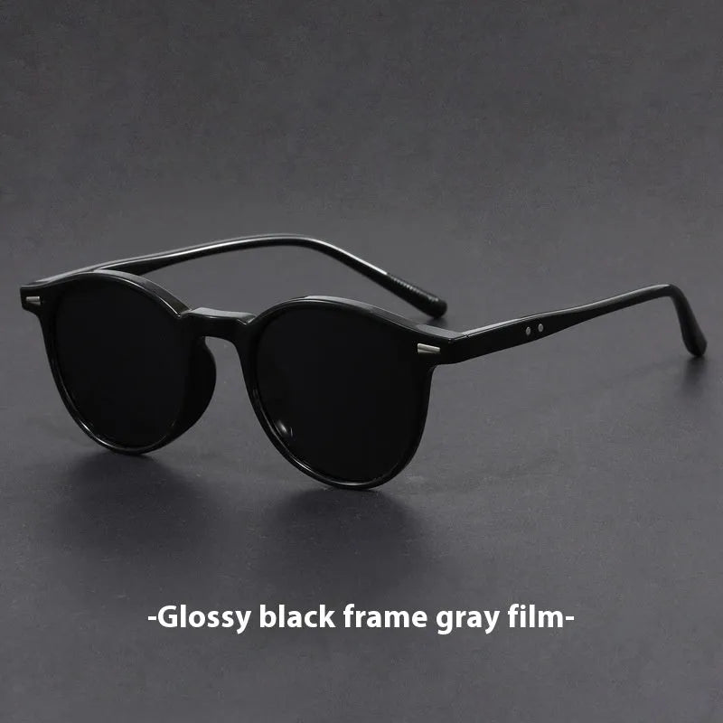 Retro oval frame sunglasses with polarised grey lenses in various frame colours on a light background