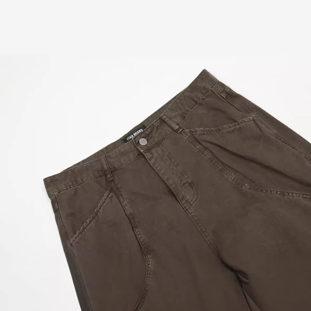 Men's brown loose straight wide-leg high-waisted cotton trousers laid flat.
