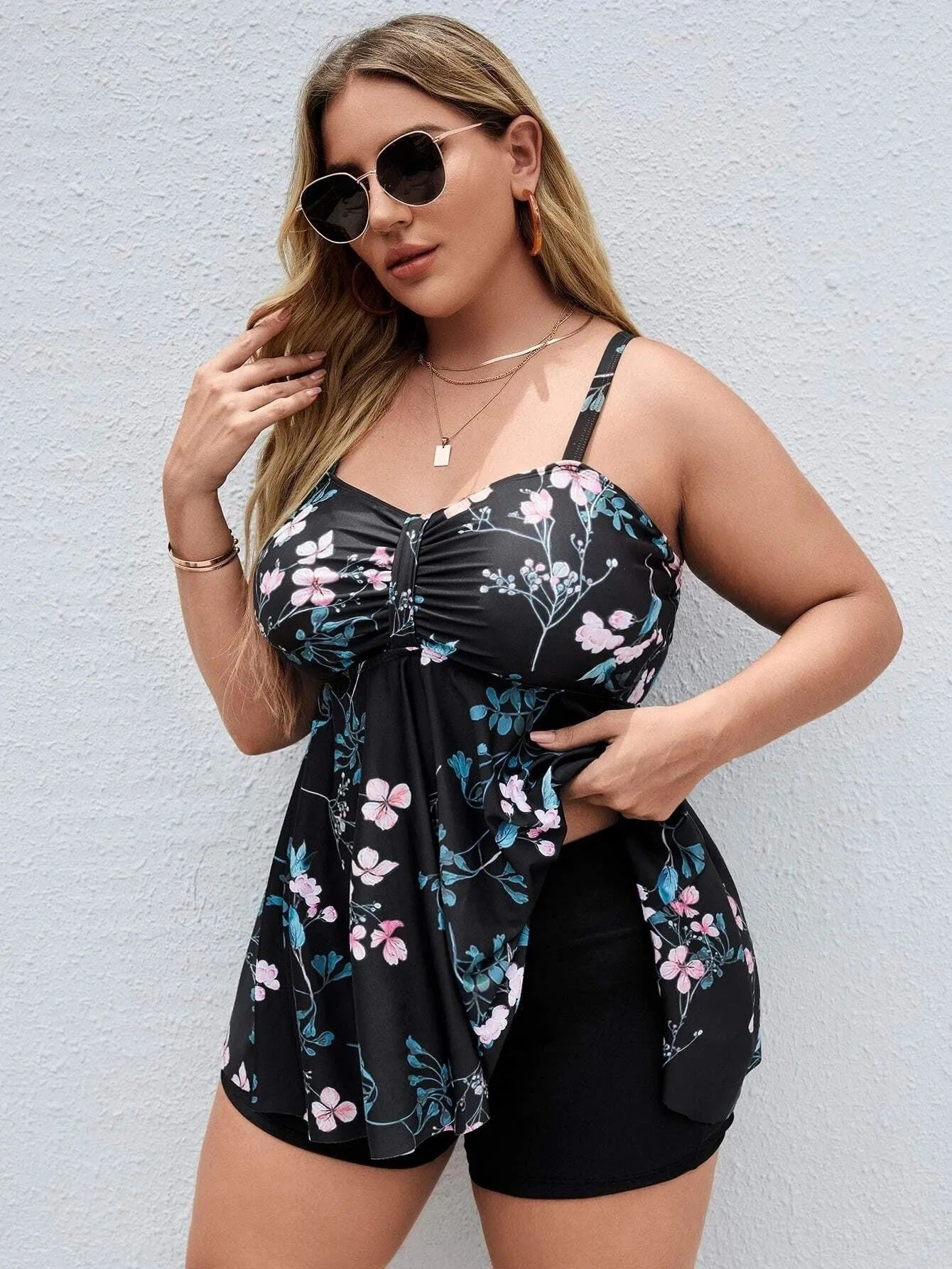 Women's floral print one-piece swimsuit on hanger, showing split colour design and high elasticity polyester fabric.