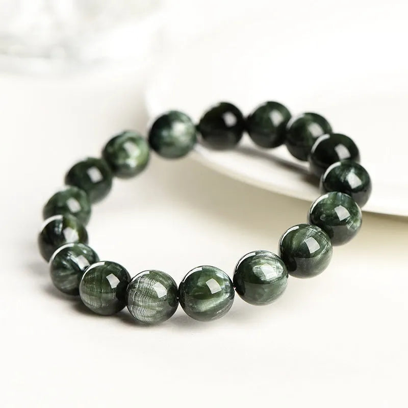 Green Dragon Crystal bracelet with 8-9mm round beads and Ruyi design elements on wrist