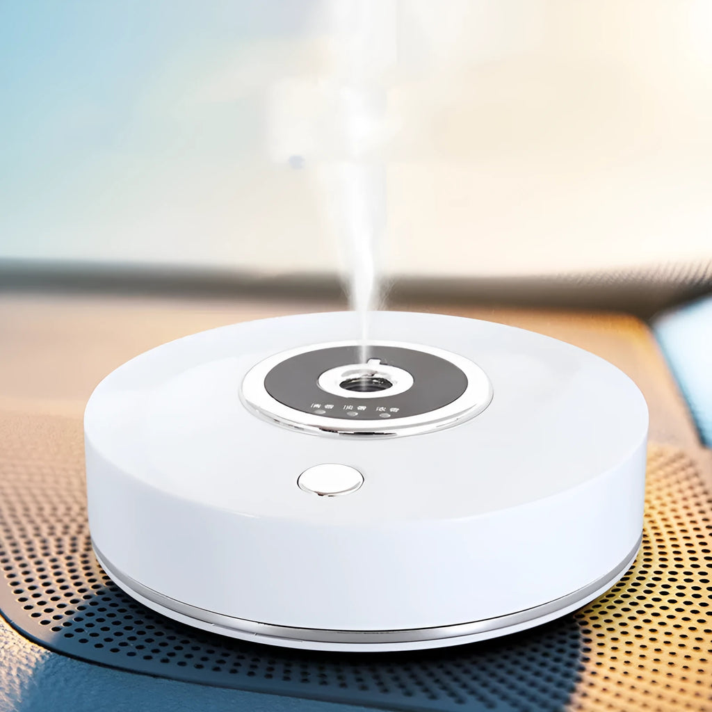 White plastic car aromatherapy diffuser with USB cable and anti-slip pad on a car dashboard.